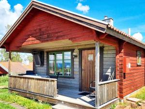 drewniany domek z werandą i tarasem w obiekcie Holiday home RÄTTVIK w mieście Rättvik