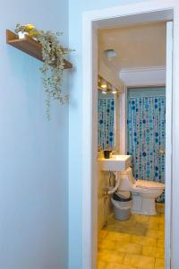 a bathroom with a toilet and a sink at Tagle Casa del Lado Santiago Providencia in Santiago