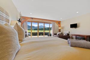 a large bedroom with a large bed with a view at Hanmer High Country Views in Hanmer Springs