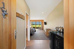 a kitchen with a counter and a dining room at Hanmer High Country Views in Hanmer Springs