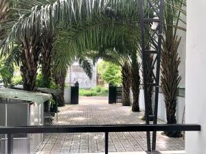 a courtyard with palm trees in a building at Green Ville Hotel Đồng Nai in Xa Dau Giay +25 photos