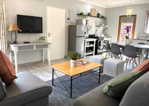 a living room with a couch and a table at Thyme Inn on Greenway in White River