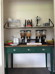 a kitchen counter with a green desk with food ingredients at Glamis Ave Shared Home B&B in New Plymouth