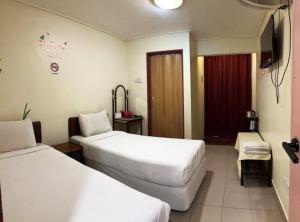 Postel nebo postele na pokoji v ubytování Hotel BB Inn @ Cameron