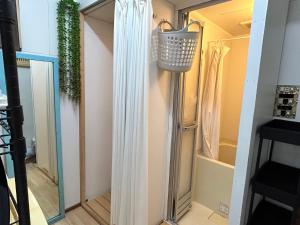a door leading into a shower in a room at Backpackers' asakusa share house "ASAKUSAGASM" in Tokyo