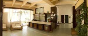 a lobby with a waiting room with chairs and a large window at Hotel Eden in San Domino
