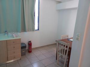 a kitchen with a table and a desk and a mirror at Serifos Palace in Livadakia