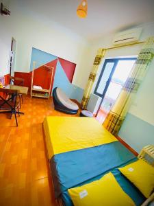 a bedroom with a bed and a table and a window at Lion Homestay in Ninh Binh