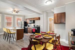 a kitchen and dining room with a table and chairs at Game/Theater Room - Barbecue - Central Location in Omaha