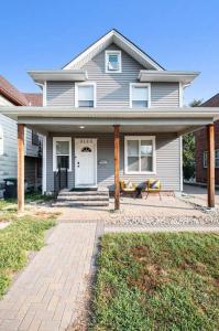 a house with a porch with a bench in front of it at Game/Theater Room - Barbecue - Central Location in Omaha