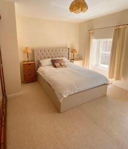 a bedroom with a large bed and a window at Cottage in the Heart of Frome in Frome