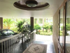 a house with a balcony with a car on it at White Butterfly -A Countryside Farmstay in Trivandrum