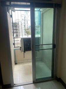 a sliding glass door in a room with a window at Lodge 61 Hotel in Bangkok