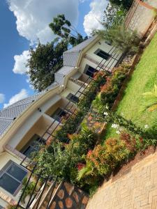 a house with plants on the side of it at Zoe heights villas in Kalungu