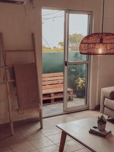 sala de estar con vistas a una puerta corredera de cristal en Departamento Nórdico en Posadas