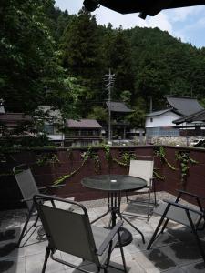 a table and chairs on a patio with a view at The　Nomad　Inn　Gujo in Gujo