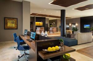 an office with a desk with a laptop and a bowl of oranges at Courtyard by Marriott Calgary South in Calgary