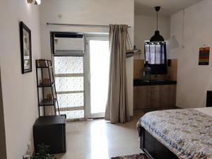 a bedroom with a bed and a large window at Krishna Nivaas Homestay in Vrindāvan