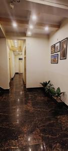 an empty hallway in a building with a plant at Bhagyashree Guest House in Varanasi