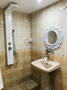 a bathroom with a sink and a mirror at Вила ОмниЯ in Chernomorets