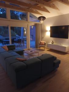 a living room with a couch and a flat screen tv at Constanza in Plau am See