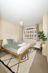 a bedroom with a bed and a window at Spacious 2 bedroom Apartment In Holborn in London