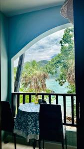 a dining room with a table and a large window at MILD ROOM SEA VIEW ROOM FOR RENT in Phi Phi Don