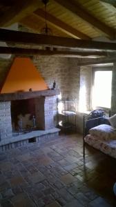 a living room with a fireplace in a house at Monpoupon in Gropparello