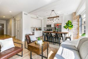 a living room with a couch and a table at Spacious 4BR Condo in New Orleans in New Orleans +51 photos