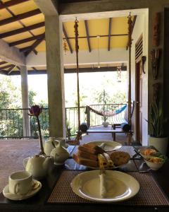 a table with a plate of food on top of it at Tantra Ella Lodge in Ella