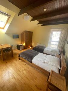 1 dormitorio grande con 2 camas y mesa en Akmenine Kerpe, en Marijampolė