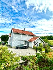 a car parked in front of a house at Villa Peaceful - Close to Lillestrøm, Ahus, Oslo Met, Kjeller, Lørenskog, Strømmen, Gardermoen Osl AirPort and NATURE in Lillestrøm