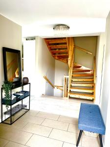 a living room with a staircase and a blue chair at Villa Peaceful - Close to Lillestrøm, Ahus, Oslo Met, Kjeller, Lørenskog, Strømmen, Gardermoen Osl AirPort and NATURE in Lillestrøm