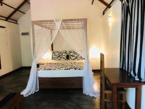 מיטה או מיטות בחדר ב-The Countryside Udawalawe