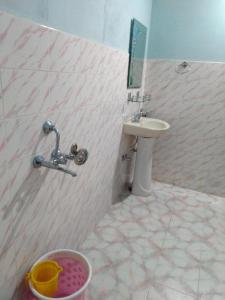 a bathroom with a sink and a toilet and a mirror at Stay Inn Pumpkin Guest House in Shillong