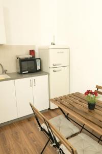 a kitchen with a table and a microwave at kotel apartment in Jerusalem