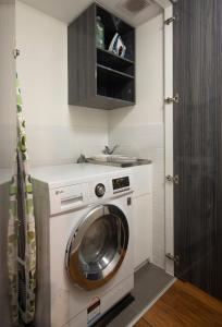 a washer and dryer in a small kitchen at The Retreat Adelaide in Adelaide