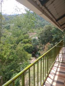 a balcony with a view of a mountain at Don's River Valley Jungle Resort in Maraiyūr