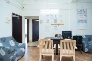 an office with a table and two chairs and a computer at JRB RESIDENCY in Dibrugarh