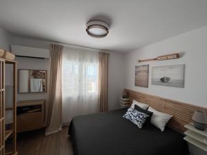 a bedroom with a bed and a window at Modern Seaview Townhouse in Coral Bay in Peyia +24 photos