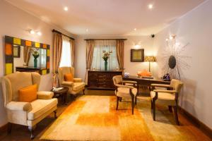 a living room with a table and chairs at The Residences at Karen in Nairobi