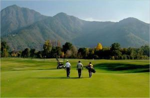 a group of three men walking on a golf course at Hotel Crown Pine Pahalgam in Anantnāg