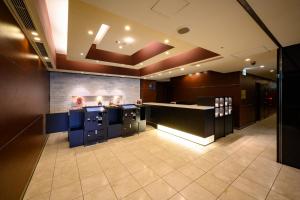 a large kitchen with blue cabinets and a counter at Hotel Keihan Asakusa in Tokyo