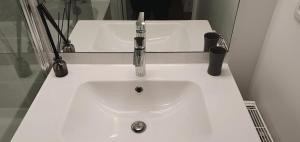 a white sink with a faucet in a bathroom at TULIPE - Spacieux appart 105 m2 -3 Ch - PARIS EXPO - CACHAN in Cachan +39 photos