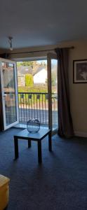 a living room with a table in front of a window at One bedroom Apartment in the heart of Horsham city centre in Horsham