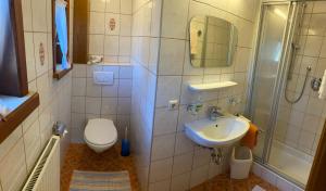 a bathroom with a toilet and a sink and a shower at Pension Schwemberger ohne Frühstück in Mayrhofen