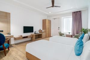 a hotel room with a bed and a television at Rudra Imperial Resort in Sītāpur