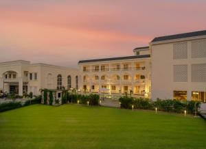 a large building with a lawn in front of it at Rudra Imperial Resort in Sītāpur