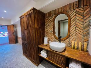 a bathroom with a sink and a mirror at Vũ House Phú Yên- Boutique Room & Breakfast in Tuy Hoa
