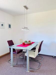 a dining room table with chairs and a blue table at Ferienwohnung Johanngeorgenstadt in Johanngeorgenstadt